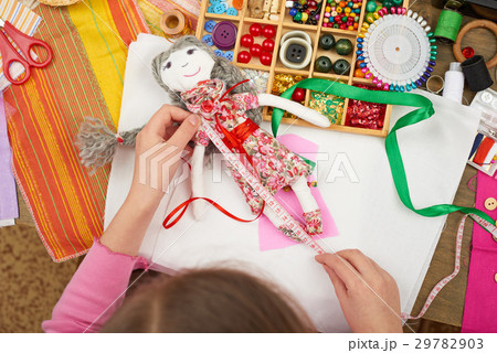 girl sews doll clothes top view sewing accessories 29782903