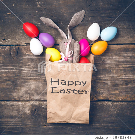Easter bunny in a paper bag on old boards Easter bunny in a paper bag on old boards 29783348