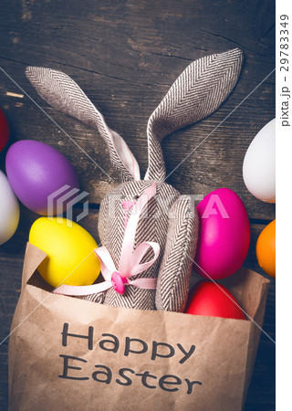 Easter bunny in a paper bag on old boards Easter bunny in a paper bag on old boards 29783349