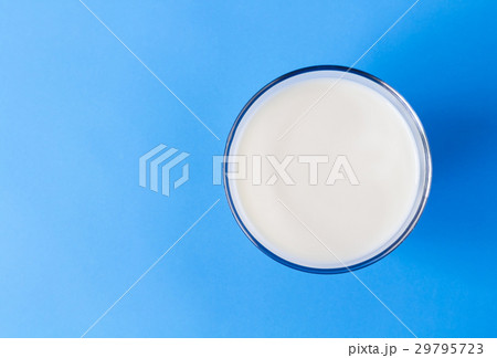 Closeup top view milk glass on blue background Closeup top view milk glass on blue background 29795723