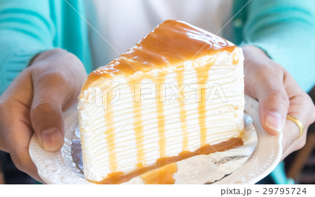 Closeup woman holding crape cake caramel 29795724