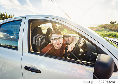 Attractive young man showing his new car keys and 29796848