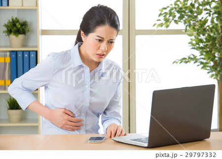 Young asian business woman with stomachache Young asian business woman with stomachache 29797332