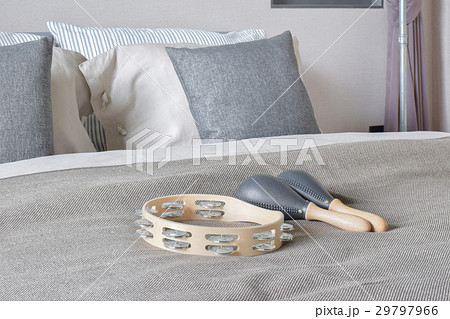 Tambourine and maracas setting on bed Tambourine and maracas setting on bed 29797966