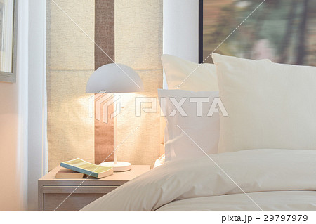 Cozy bedroom with pillows and reading lamp Cozy bedroom with pillows and reading lamp 29797979