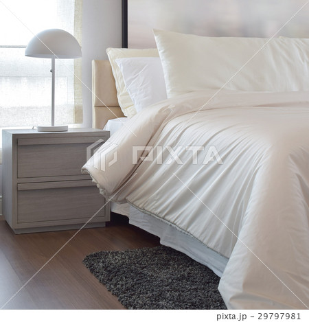 Cozy bedroom with pillows and reading lamp Cozy bedroom with pillows and reading lamp 29797981
