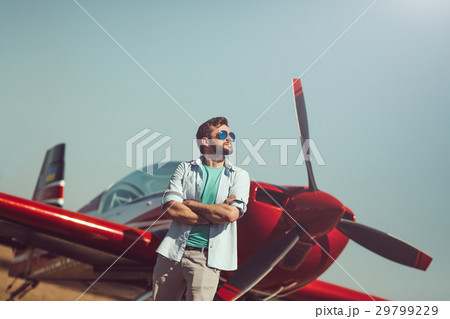Man in front of vintage plane 29799229