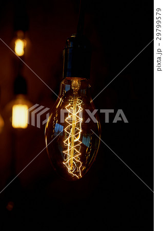 Edison light bulb hanging on a long wire. Cozy Edison light bulb hanging on a long wire. Cozy 29799579