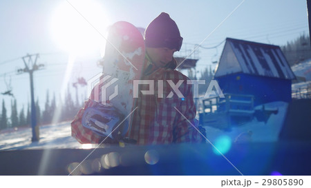 Snowboarder goes on in line to the ski lift at the 29805890