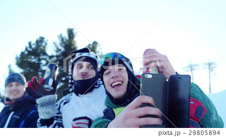 Group of young snowboarders on the slopes in sunny Group of young snowboarders on the slopes in sunny 29805894