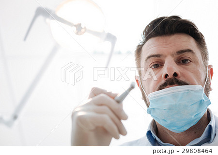 Successful committed dentist at work 29808464
