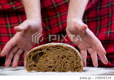 male hand under bread loaf male hand under bread loaf 29808529