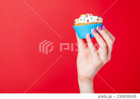 photo of female hand holding cupcake 29808688