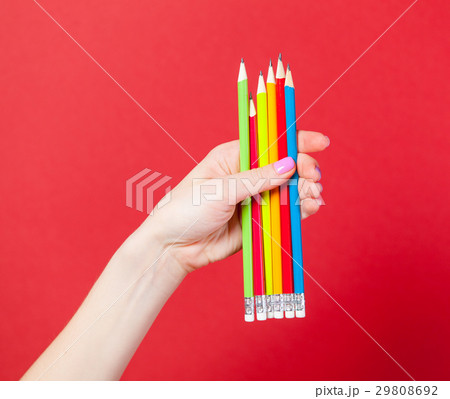 photo of female hand holding colorful pencils 29808692