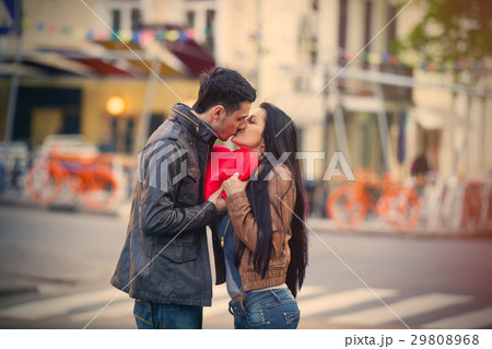 photo of cute couple holding heart shaped pillow photo of cute couple holding heart shaped pillow 29808968