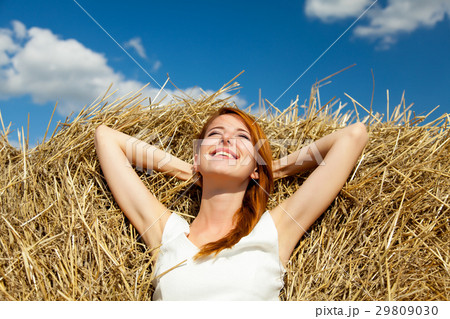 photo of beautiful young woman lying on the hay photo of beautiful young woman lying on the hay 29809030