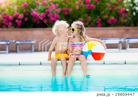 Kids playing at outdoor swimming pool 29809447