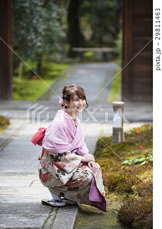 A Young Woman With A Smile Of A Crouching Stock Photo