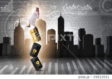 Arab businessman losing balance on oil barrels 29812031