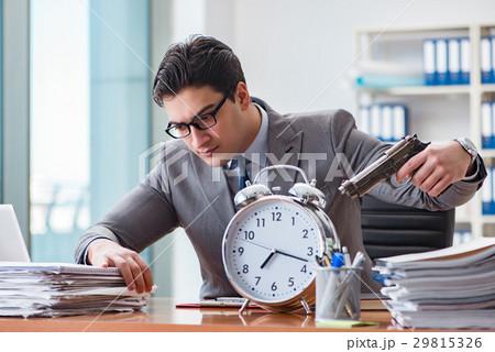 Young businessman in time management concept 29815326