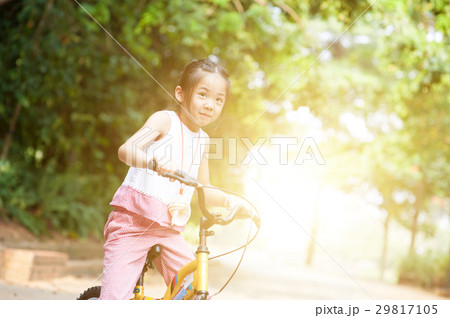 Asian child riding bicycle outdoor. Asian child riding bicycle outdoor. 29817105