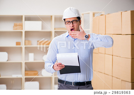 Young worker in the postal office dealing with 29819363