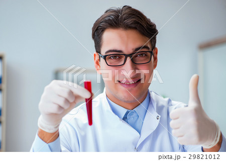 Doctor with red blood sample Doctor with red blood sample 29821012