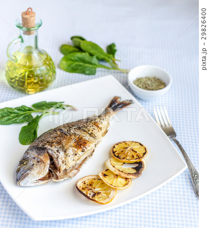 Grilled dorada fish with lemon and spinach Grilled dorada fish with lemon and spinach 29826400