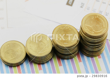 bar graph of Gold coins on paper documents. bar graph of Gold coins on paper documents. 29830916