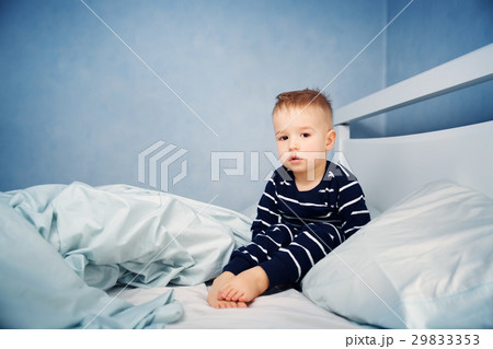 Sleepy boy sitting in bed Sleepy boy sitting in bed 29833353