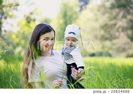 Mother and son shows the grass Mother and son shows the grass 29834686