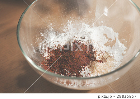 Cocoa powder with bakers flour in glass bowl. Cocoa powder with bakers flour in glass bowl. 29835857