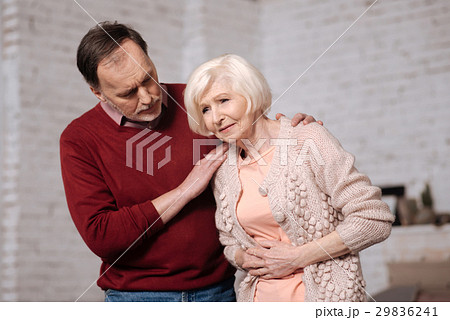 Senior man supporting his wife with stomachache. 29836241