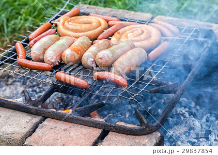Tasty pork and beef sausages cooking  29837854
