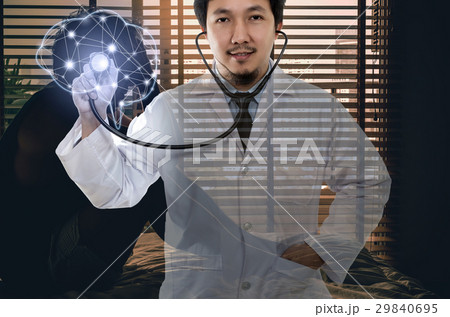 Asian Doctor hand holding the stethoscope equipment on brain over depressed man sitting head in hands on the bed in the dark bedroom, physician of darmatic concept Asian Doctor hand holding the stethoscope equipment on brain over depressed man sitting head in hands on the bed in the dark bedroom, physician of darmatic concept 29840695
