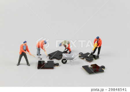 people collaborate holding up  puzzle pieces 29848541