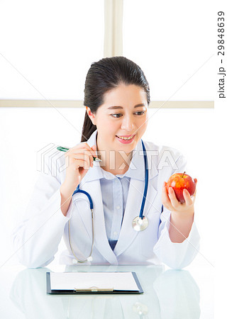 Young asian nutritionist doctor writing diet plan Young asian nutritionist doctor writing diet plan 29848639