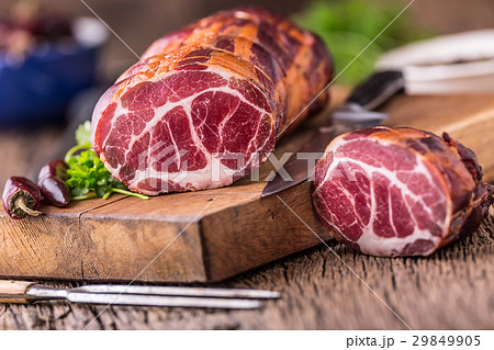 Traditional smoked pork meat on oak wooden table. Traditional smoked pork meat on oak wooden table. 29849905