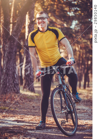 man cyclist rides in the forest on a mountain bike man cyclist rides in the forest on a mountain bike 29850140