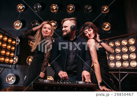 Two beautiful girls in nightclub dancing with DJ 29850467