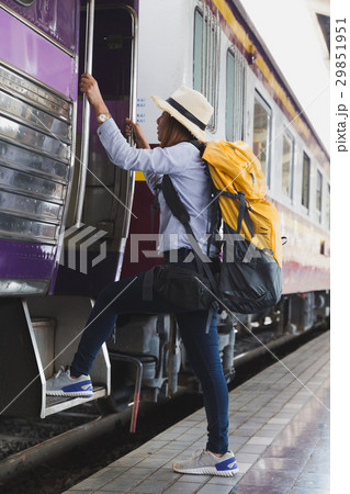 Traveler girl with backpack walk up the train  29851951