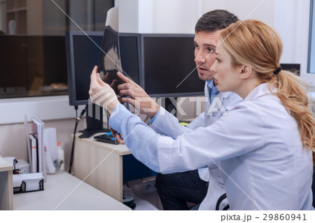 Nice professional doctors looking at the x ray Nice professional doctors looking at the x ray 29860941