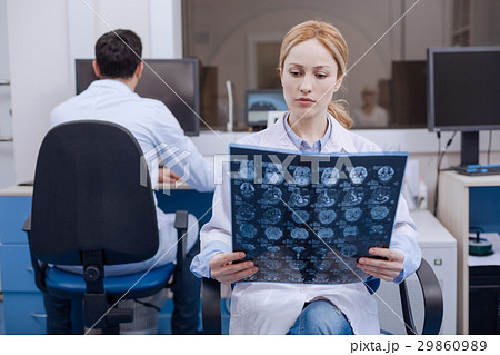 Nice female doctor examining X ray image 29860989
