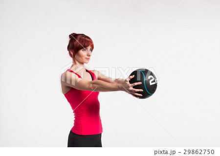 Fitness woman in red tank top holding medicine Fitness woman in red tank top holding medicine 29862750