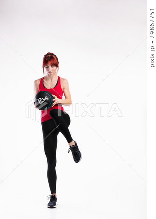 Fitness woman in red tank top holding medicine Fitness woman in red tank top holding medicine 29862751