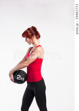 Fitness woman in red tank top holding medicine Fitness woman in red tank top holding medicine 29862753