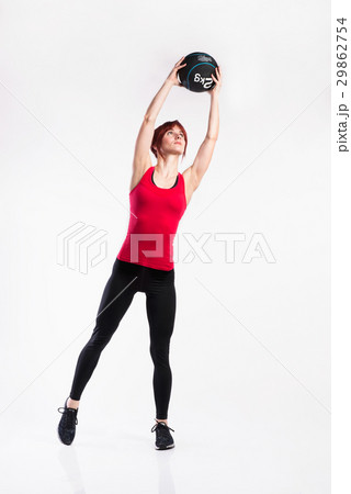 Fitness woman in red tank top holding medicine Fitness woman in red tank top holding medicine 29862754