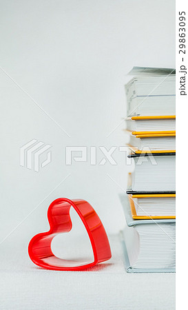 One heart shape lean on books pile placed on the 29863095