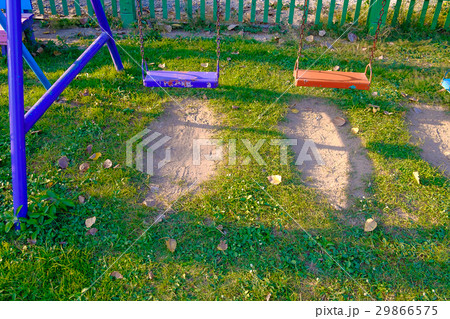 Empty chain and metal swings in playground Empty chain and metal swings in playground 29866575