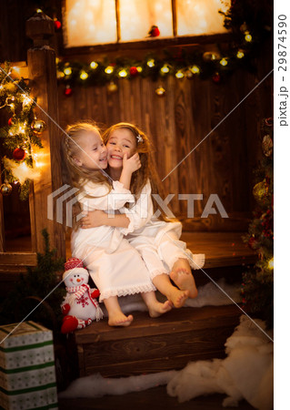Girl sister friends hugging sitting Christmas tree Girl sister friends hugging sitting Christmas tree 29874590